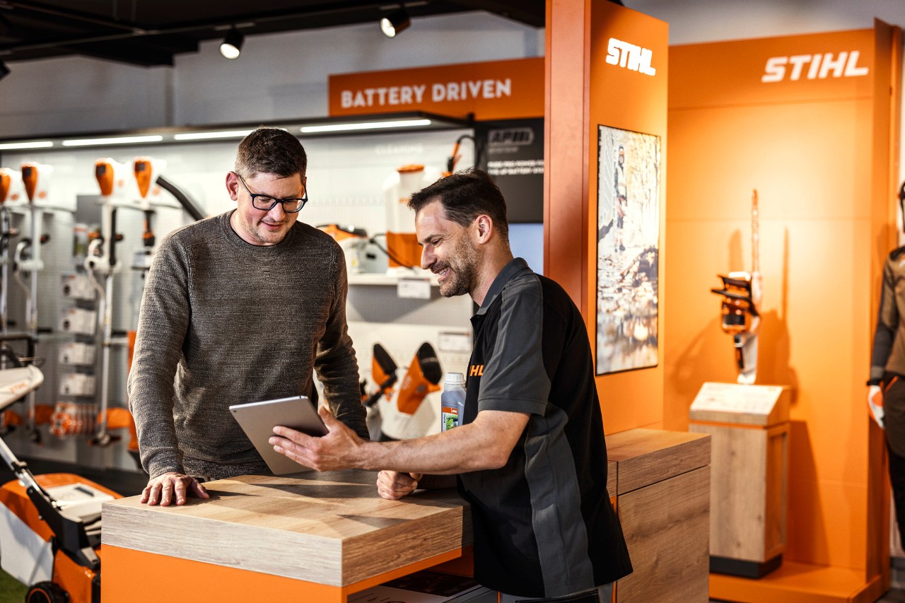 A STIHL dealer advises a customer in a showroom
