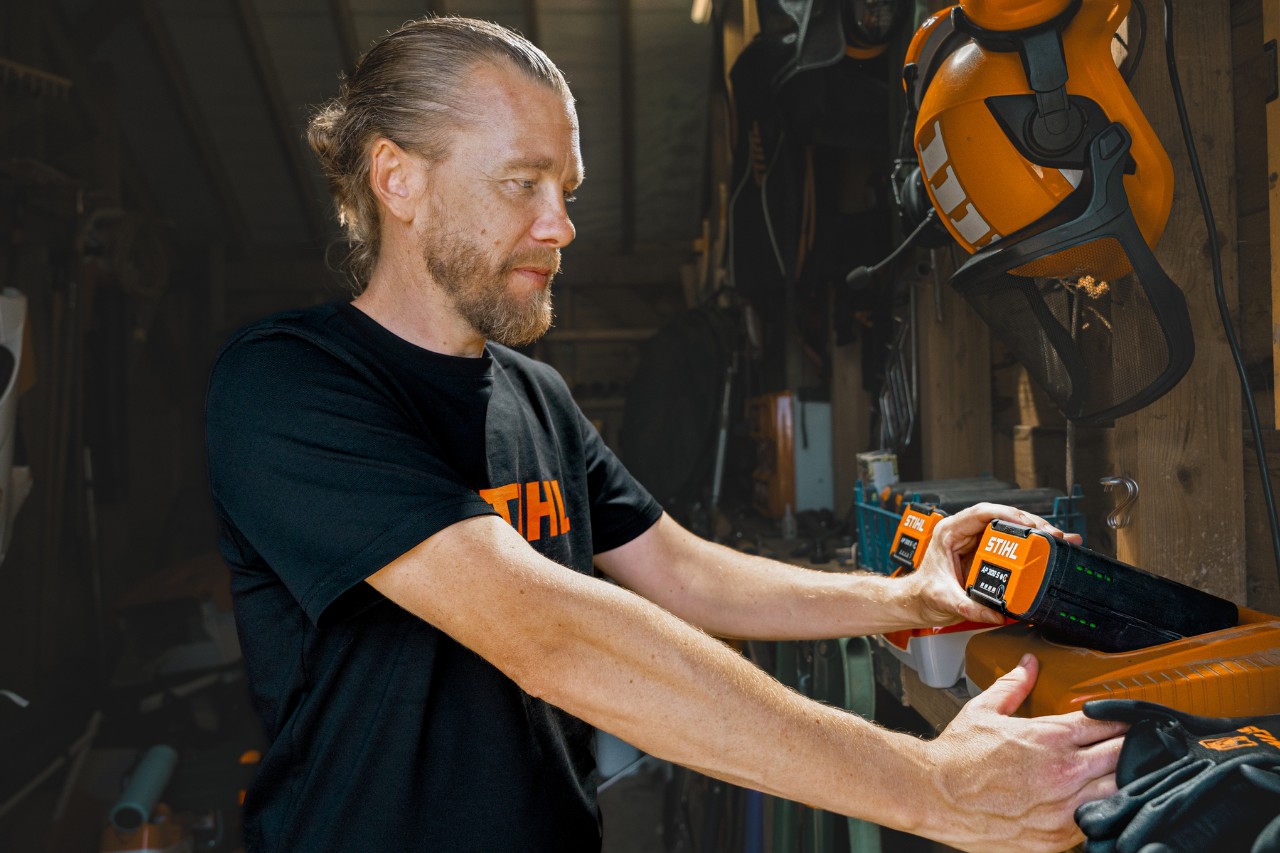 Andrew Wain places a battery in a STIHL high-speed charger