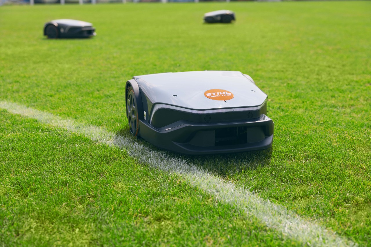 Three iMOW® 7 Pro mowers in a sports field